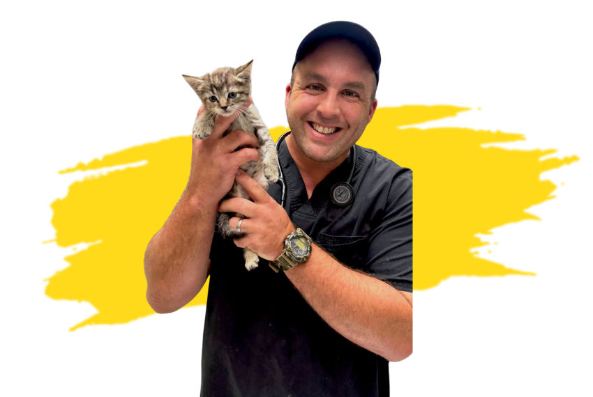 two men holding puppies posing for a picture